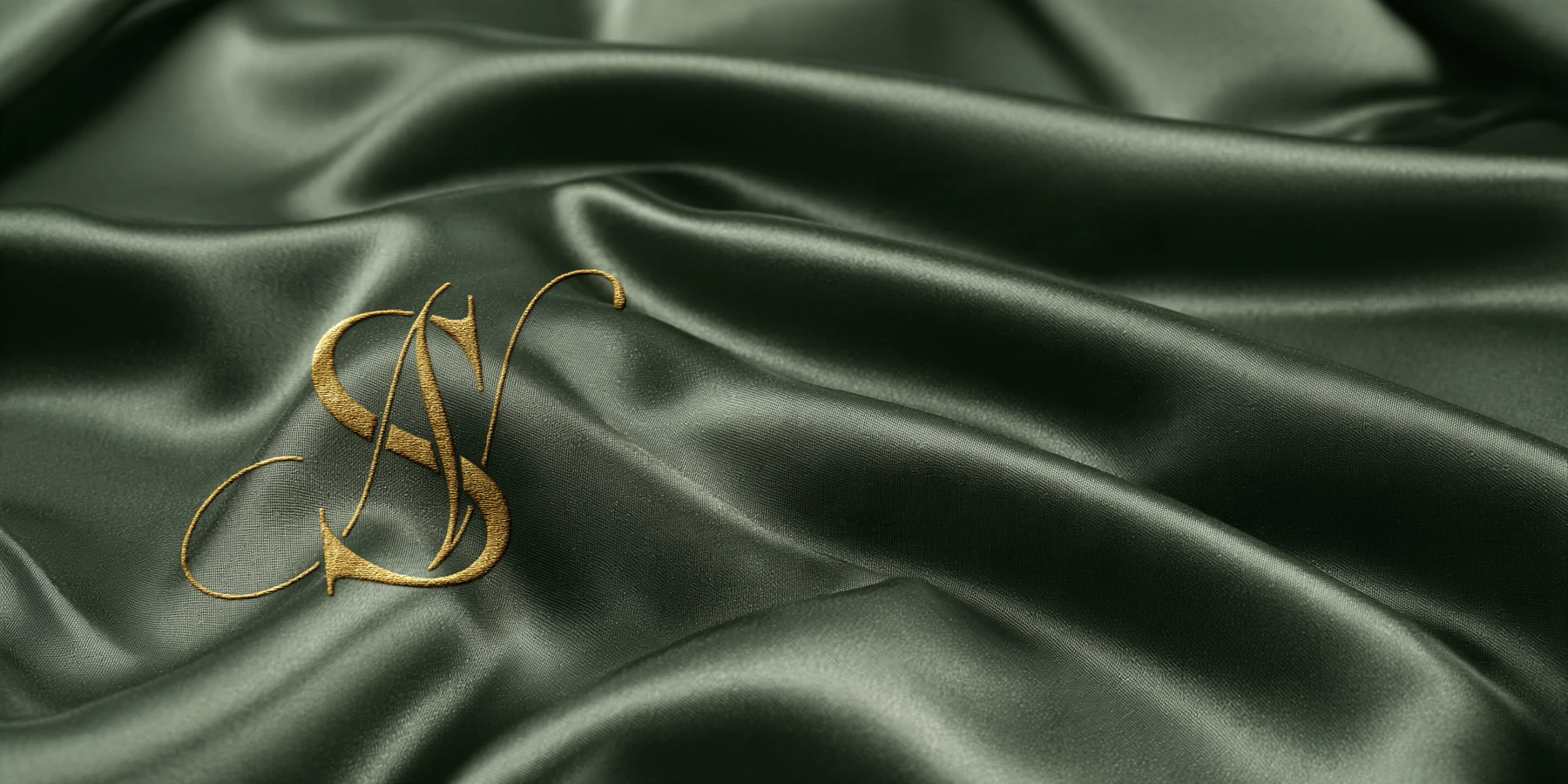 Natali’s gold embroidered monogram on green silk